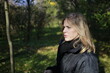 © indigolotos - A young woman walks through the autumn park.