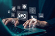 © panya7 - Hand use laptop with virtual GEO generative engine optimization interface and AI icon, representing digital marketing, automation, data analytics and artificial intelligence driven business technology