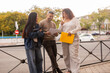 © ADDICTIVE STOCK - Multiethnic friends sharing ideas in the city
