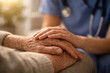 © thodonal - Caregiver holding elderly patient's hands in a comforting gesture