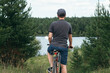 © ADDICTIVE STOCK - Cyclist enjoying serene view by the lake in nature