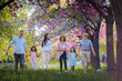 © Halfpoint - Three generation family sitting outside in spring nature.
