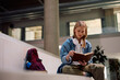 © Drazen - University student studying from book at lecture hall.