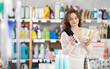 © JackF - Young woman buyer chooses hairbrush in household chemicals store