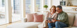 © Jasmine - Candid photo of happy middle aged couple using digital tablet relaxing on couch at home. Smiling mature man and woman holding tab browsing internet on pad device sitting on sofa in living room.