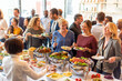 © Rawpixel.com - Diverse group enjoying buffet meal.