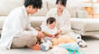 © buritora - Families with young children and babies playing in their living rooms (childcare, parenting, physical contact)