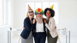 © Pei - April Fools Day diverse businesswomen team props celebration laughing office diversity teamwork joy fun workplace corporate marketing advertising