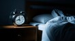 © Paul - A ticking clock on a bedside table next to an unmade bed in a dark room where late night shadows create a feeling of quiet restlessness, shadow, evening, home