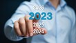 © MDABU - Future planning and goal setting concept hand pointing at future years including 2023, 2024, 2025, and 2026