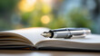 © Nataliya - Pen hovering over a blank open notebook in soft window light, creative writing and planning lifestyle concept, defocused background, with copy space