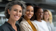 © Nataliya - Diverse group of confident professional women smiling together in a modern workspace, female leadership and collaboration lifestyle concept, defocused background, with copy space