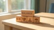 © AspctStyle - Wooden blocks with wellness icons representing life balance on sunlit office desk
