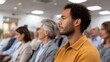 © Bussakon - Diverse audience attentively listening in a modern conference room during a presentation