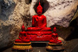 © Anirut - Ancient red buddha statues in cavern mountain for thai people travelers travel visit respect pray blessing wish holy worship mystery myth at antique Wat Khao Yoi Cave Temple in Phetchaburi, Thailand