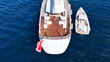 © aerial-drone - Aerial drone photo of beautiful luxury sail boat with wooden deck anchored in deep blue Mediterranean sea