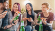 © InsideCreativeHouse - Young friends sharing pizza and beer indoors at home, laughing and having fun, casual gathering, entertainment, leisure, socializing, cozy lifestyle and weekend relaxation concept