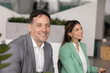 © fizkes - Portrait smiling middle aged businessman looking at camera taking brief pause from listening on corporate event conference training or seminar feeling relaxed confidence in positive workplace culture