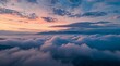 © Budi - Panoramic Cloudscape Above Mountain Peaks Bathed in Golden Hour Light