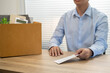 © Charlie's - sending resignation letter to boss and Holding Stuff Resign Depress or carrying cardboard box by desk in office