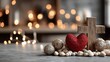 © MKS - A red heart rests on a wooden Christian cross set in gravel, signifying divine love, faith, and spiritual redemption