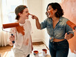 © Abhi - Two women — painting walls of new apartment, laughing with paint on faces