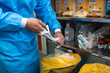 © Graphicroyalty - Medical professional removing sterile surgical gloves after operation. Surgeon taking off protective rubber gloves in hospital operating room near medical waste bin. Hygiene and safety protocols.