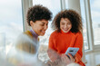 © Westend61 - Young women with curly hair smiling and talking on windowsill indoors