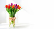 © MdFarhad - A vibrant bouquet of colorful tulips in a clear glass vase on a white background