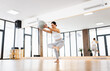© Zoran Zeremski - Woman doing pilates stretching with ball in bright mirror studio.