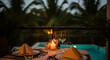 © Parveen - Tropical hotel swimming pool at night by the beach with palm trees and ocean view in a relaxing summer paradise resort