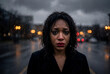 © Schizarty - Sad crying African-American woman with smudged mascara and red lipstick on face looking at camera on wet city street at night in rain with bokeh light in gothic vampire aesthetic