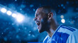 © Favio - Football player wearing blue and white jersey shouting celebration during world cup match under stadium lights at night.