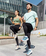 © muse studio - Fit man and woman exercising with high knees in an urban setting on a sunny day