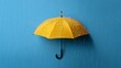 © Nataliia_Trushchenko - Yellow umbrella with water droplets hanging against a blue background, showcasing a vibrant contrast and emphasizing the rainy weather theme