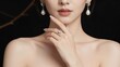 © designitsme - Womans face and bare shoulders with hand near chin wearing earrings and ring on finger  elegant lady with jewelry