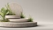 © malayeka - Tiered circular stone display platform features natural green foliage against a muted background