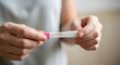 © mdsultan - Close up of a person holding a positive pregnancy test isolated on transparent background