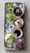 Exquisite culinary ice platter with three gourmet dishes and edible flowers