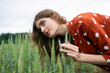 © Westend61 - Woman with curly hair in red blouse smiling in wheat field in summer