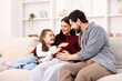 © New Africa - Pregnant woman, her husband and daughter on sofa at home