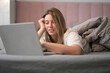 © Sergey Mironov - Lighthearted Browsing While Resting Comfortably in Bed