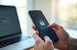 © miss irine - Person logs into secure account using phone and laptop. One time password verification enhances online safety. Digital security and data protection.
