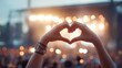 © elimicel - Hands forming heart shape at concert