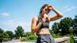 © Zenturio Designs - Athletic woman eating ice cream sweating resting after workout park