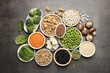 © New Africa - Different vegan products on grey table, flat lay. Source of protein