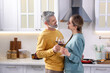 © New Africa - Lovely couple with glasses of wine in kitchen