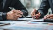 © Ameer - Asian business adviser analyzing financial report in meeting room, professional investment consultant and accounting discussion concept
