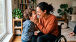 © Маргарита Пархоменко - Mother in wheelchair shares a tender, joyful moment with her young son at home