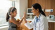 © PRASANNAPIX - Caring doctor high-fives happy little girl in clinic.